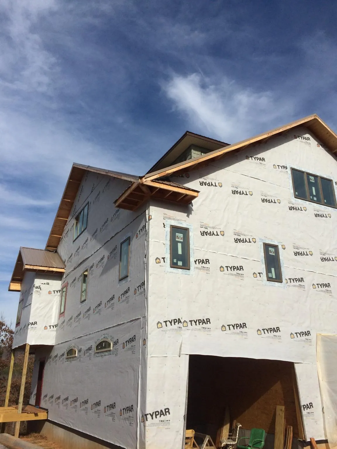 Stick built house wrapped in Typar with new roof framing and dormers in Geneva